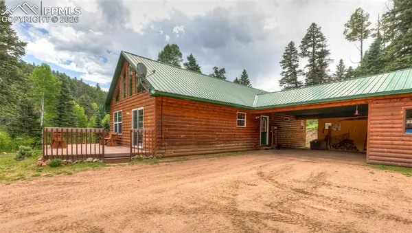 a view of a house with a yard and garage