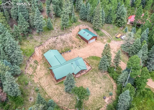 an aerial view of a house with a yard