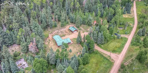 an aerial view of a house with a yard