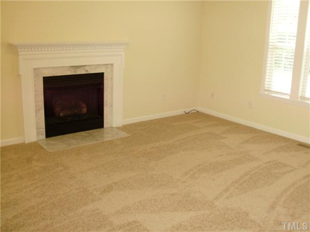 4619 Sinclair Drive Raleigh, NC 27616 - Photo 3 of 9 an empty room with a fireplace