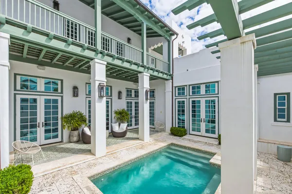 a front view of multi story residential apartment building with yard and green space