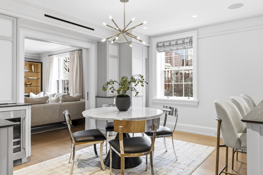 25 Beacon Street, Unit 4 Boston, MA 02108 - Photo 15 of 41 a dining room with furniture potted plants and wooden floor