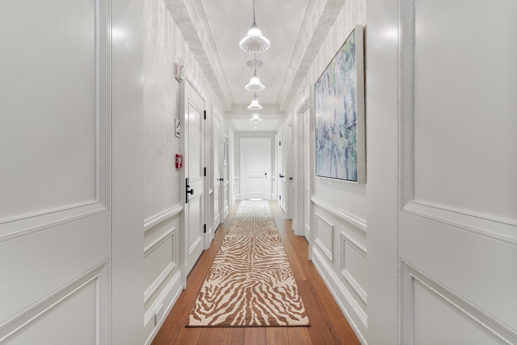 25 Beacon Street, Unit 4 Boston, MA 02108 - Photo 25 of 41 a view of a hallway with wooden floor and cabinet