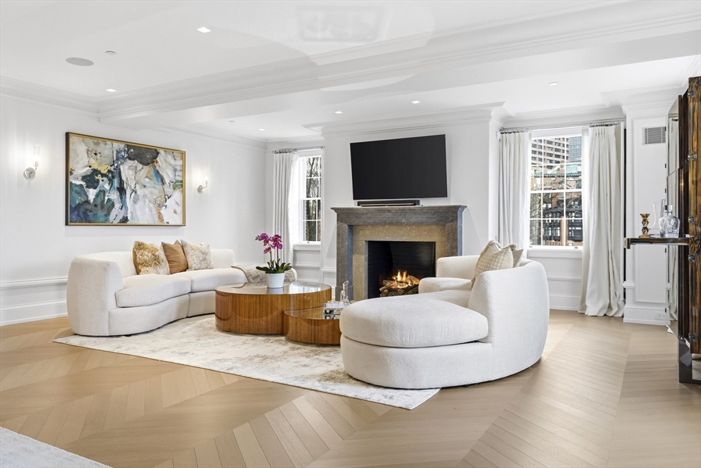 25 Beacon Street, Unit 4 Boston, MA 02108 - Photo 5 of 41 a living room with furniture a flat screen tv and a fireplace