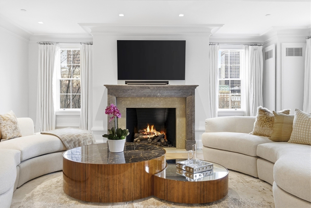 25 Beacon Street, Unit 4 Boston, MA 02108 - Photo 8 of 41 a living room with furniture a fireplace and a flat screen tv