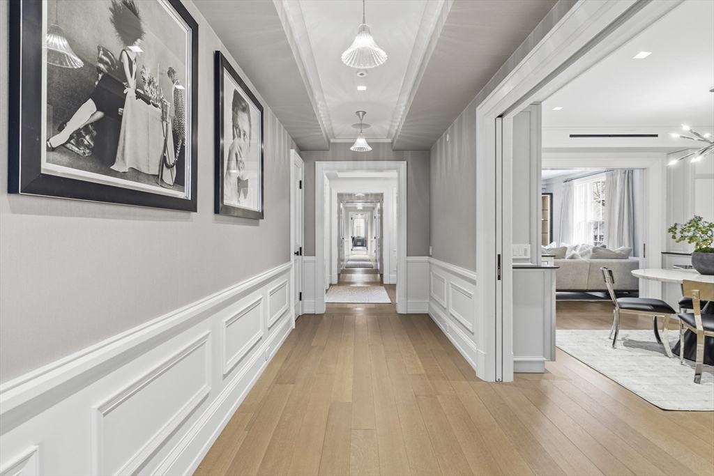 25 Beacon Street, Unit 4 Boston, MA 02108 - Photo 10 of 41 a view of a hallway with wooden floor and staircase