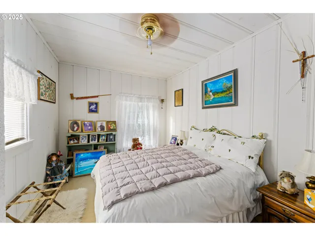 a bathroom with a sink vanity granite tub and a window