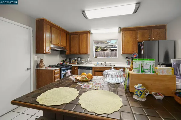 a kitchen with a table chairs and a refrigerator