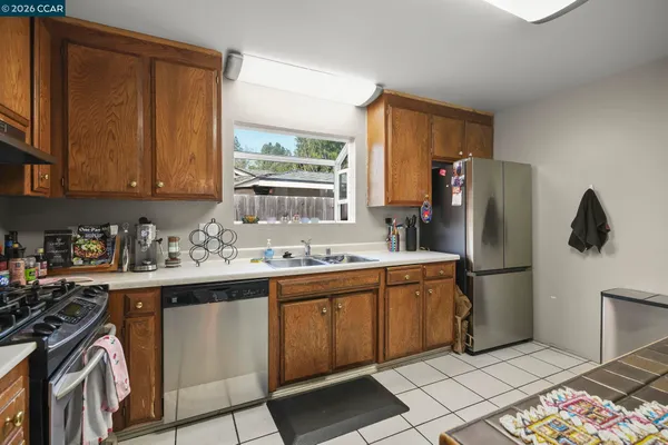 a kitchen with a sink appliances and cabinets