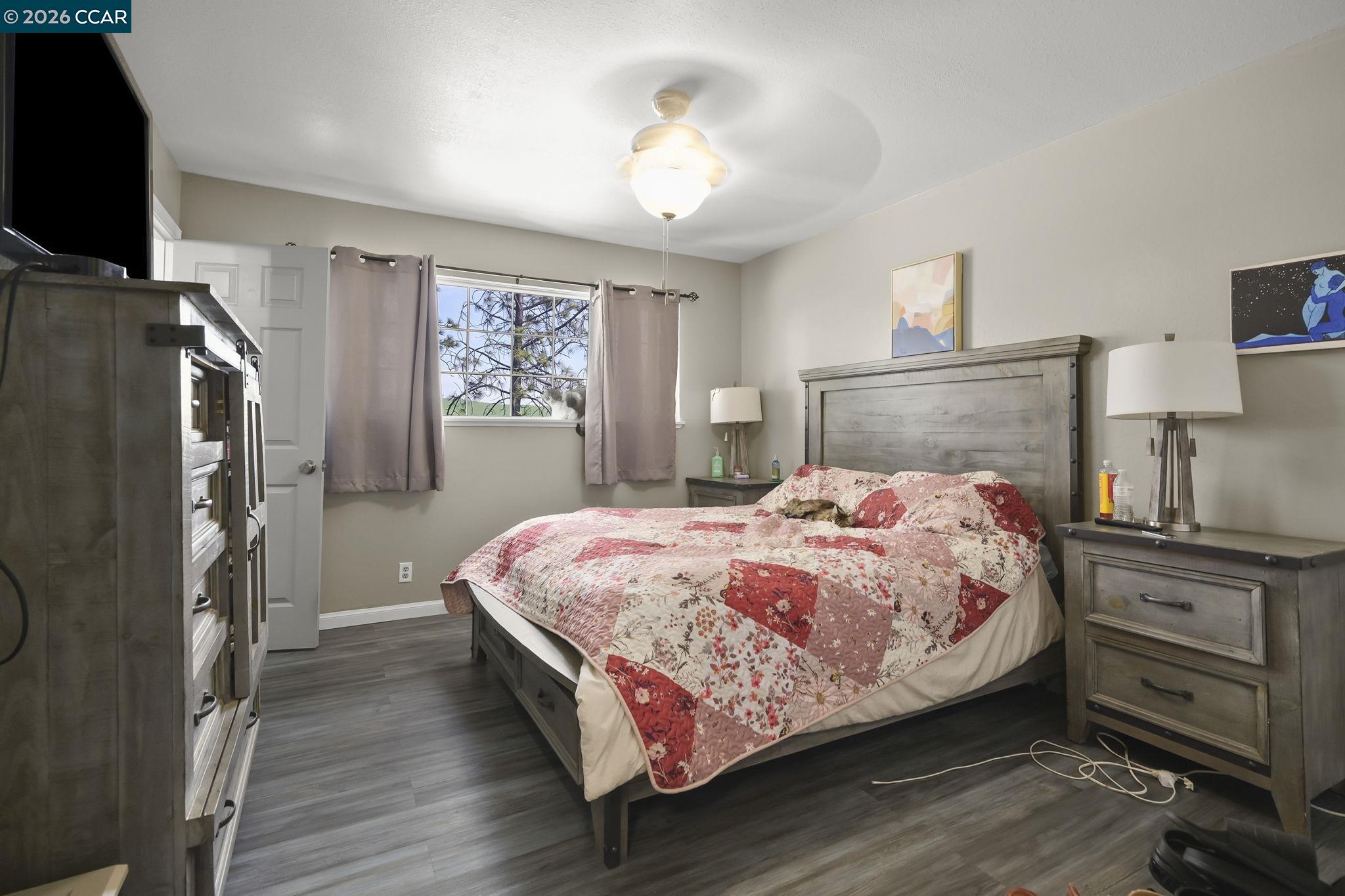 3922 Bayview Circle Concord, CA 94520 - Photo 15 of 30 a bedroom with a bed dresser and a flat tv screen