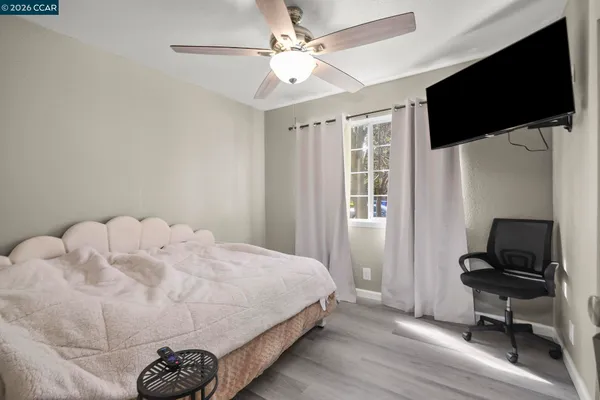 a bedroom with a bed and a flat screen tv