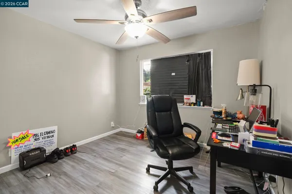 a work room with furniture and wooden floor