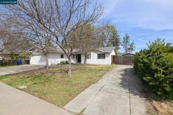 a view of a white house with a yard