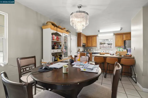 a view of a dining room with furniture and chandelier