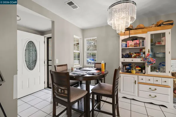 a dining room with furniture a chandelier and a rug