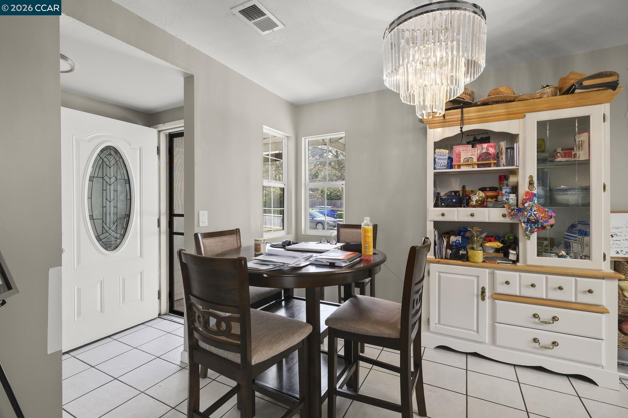 3922 Bayview Circle Concord, CA 94520 - Photo 10 of 30 a dining room with furniture a chandelier and a rug