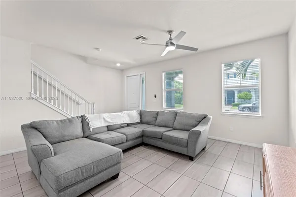 a living room with furniture and a window