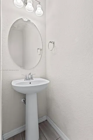a bathroom with a sink and mirror