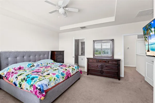 a bedroom with a bed and a dresser