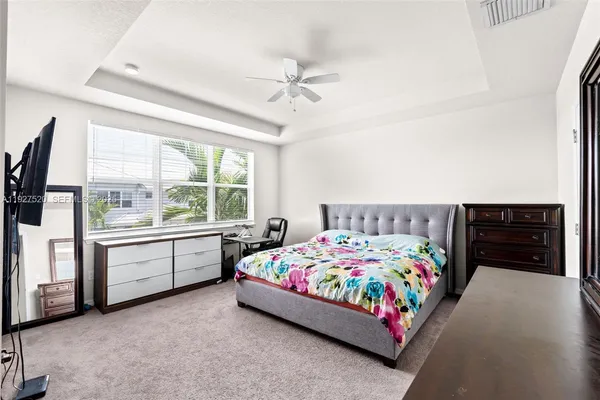 a bedroom with a bed and a larger window