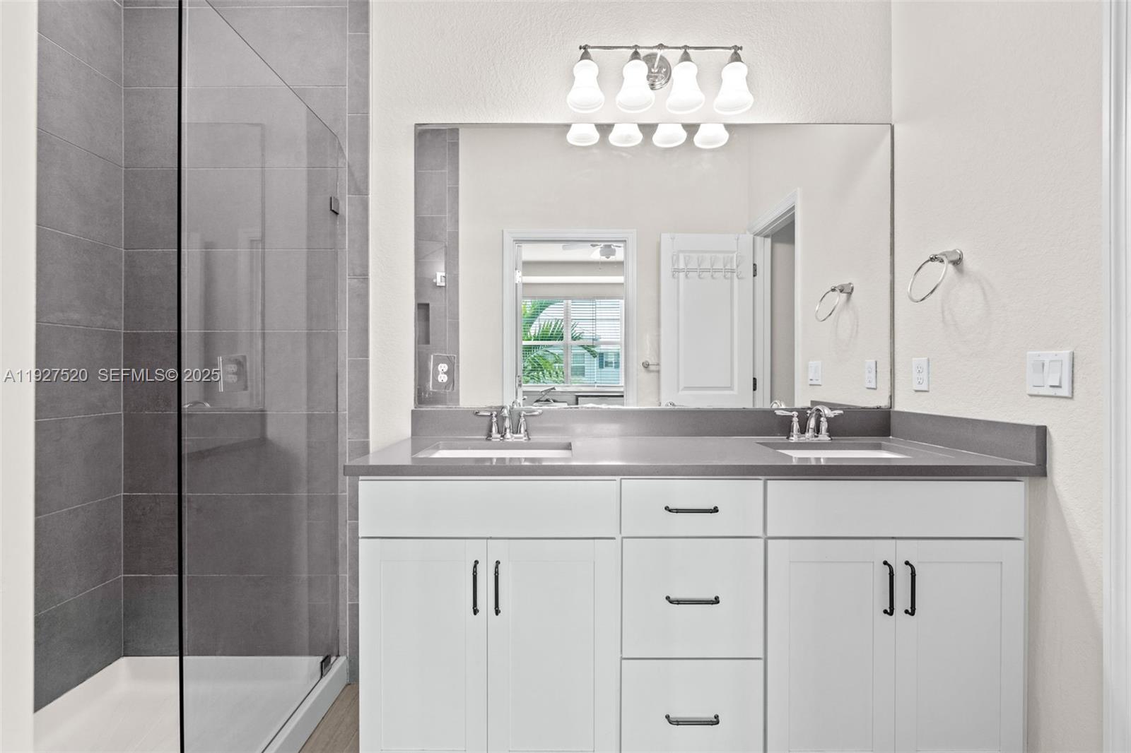 1190 Eucalyptus Drive, Unit 5 Hollywood, FL 33021 - Photo 24 of 42 a bathroom with a granite countertop sink a mirror and a shower