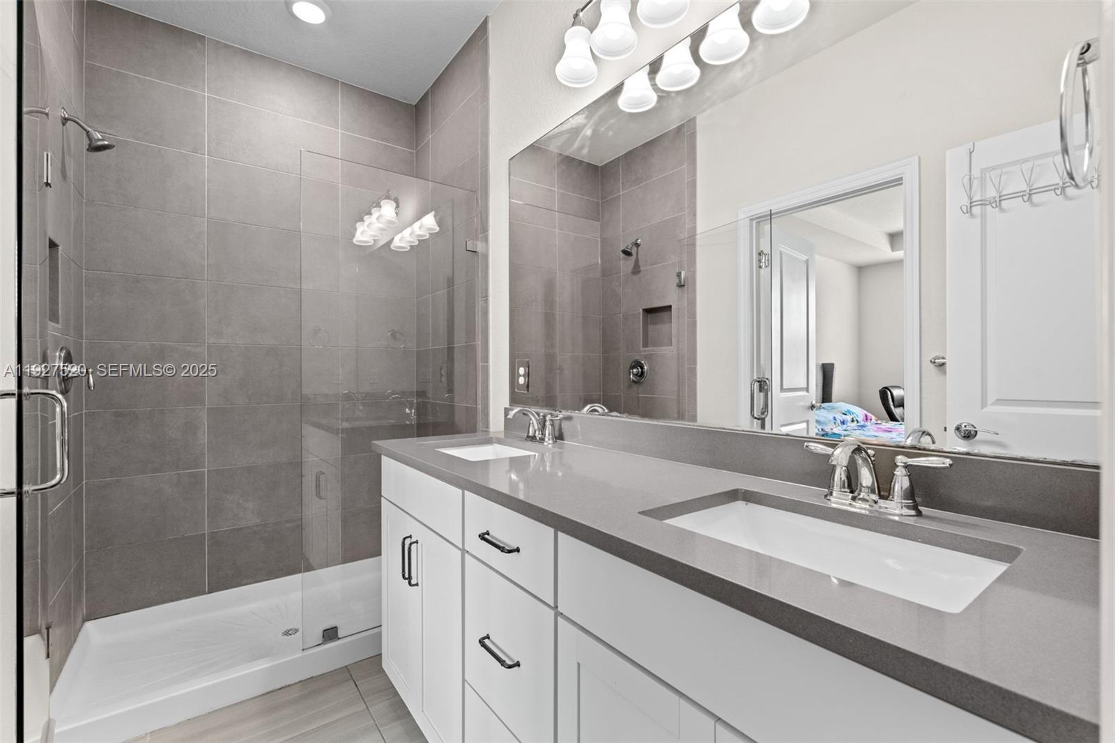 1190 Eucalyptus Drive, Unit 5 Hollywood, FL 33021 - Photo 25 of 42 a bathroom with a sink double vanity granite tub and shower