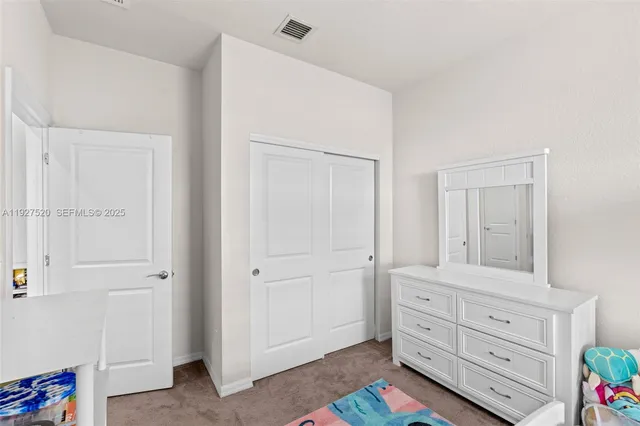 a room that has a dresser in it