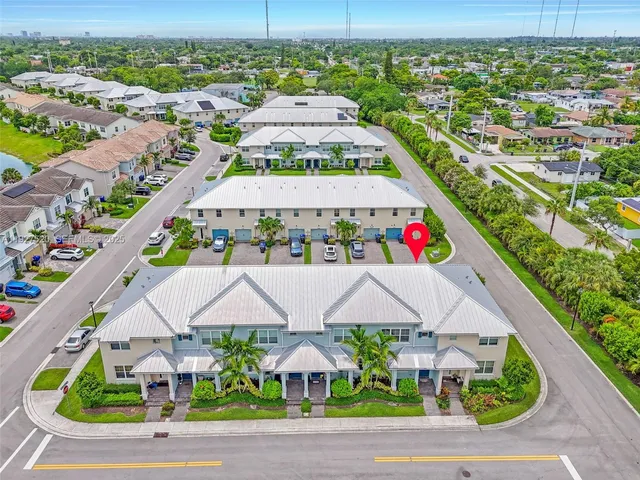 an aerial view of residential houses with outdoor space and street view