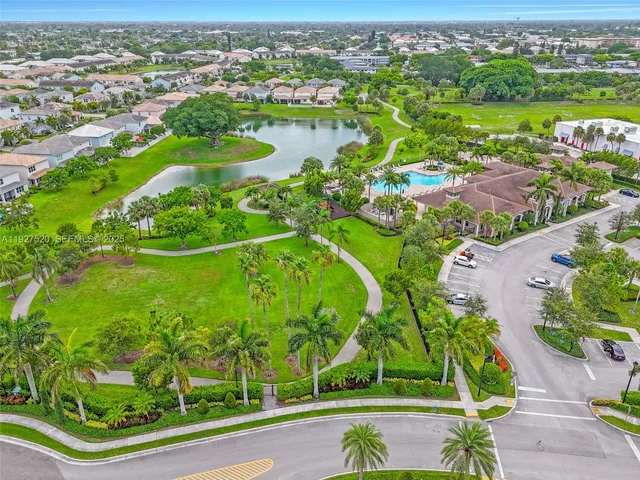 an aerial view of lake residential houses with outdoor space and trees
