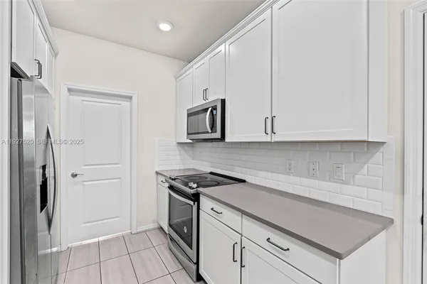 a kitchen with a stove and a refrigerator