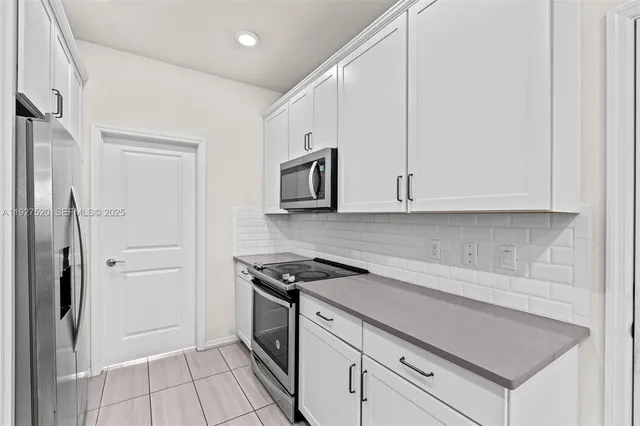 a kitchen with a stove and a refrigerator