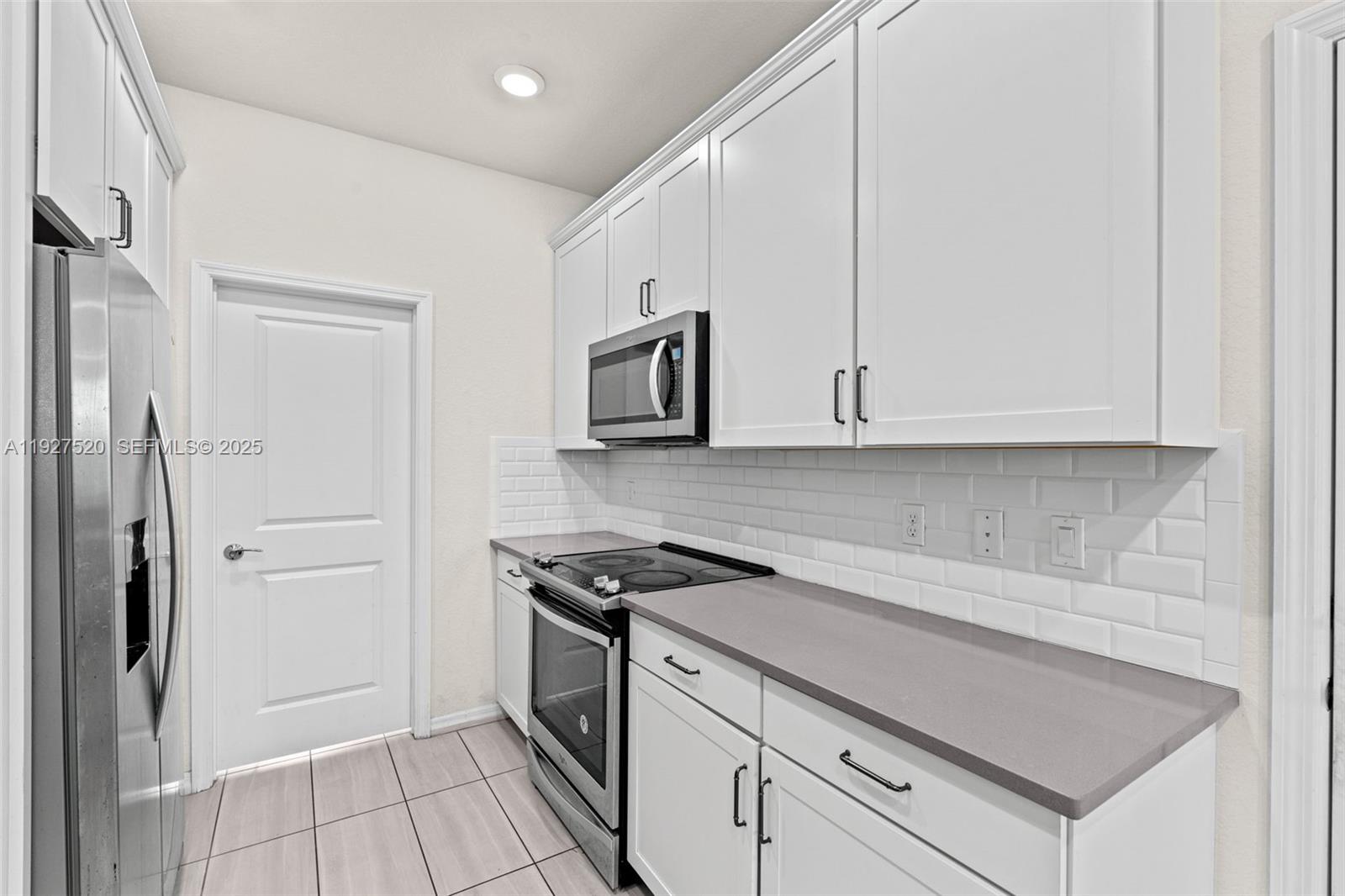 1190 Eucalyptus Drive, Unit 5 Hollywood, FL 33021 - Photo 6 of 42 a kitchen with a stove and a refrigerator