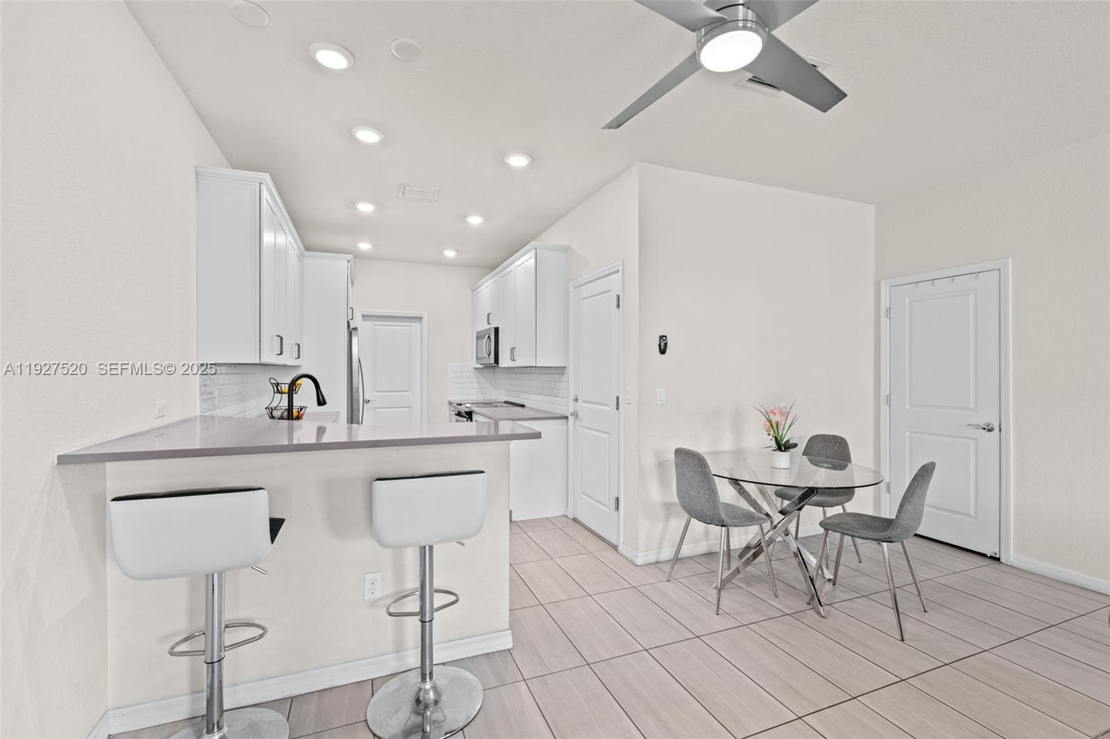 1190 Eucalyptus Drive, Unit 5 Hollywood, FL 33021 - Photo 8 of 42 a kitchen with a sink cabinets and window