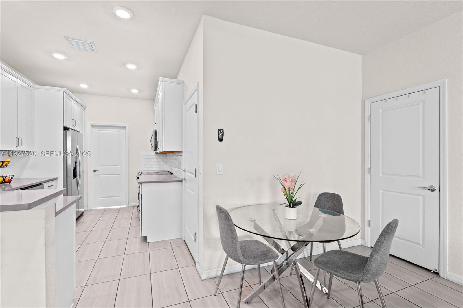 1190 Eucalyptus Drive, Unit 5 Hollywood, FL 33021 - Photo 9 of 42 a kitchen with stainless steel appliances kitchen island granite countertop a refrigerator and a stove top oven