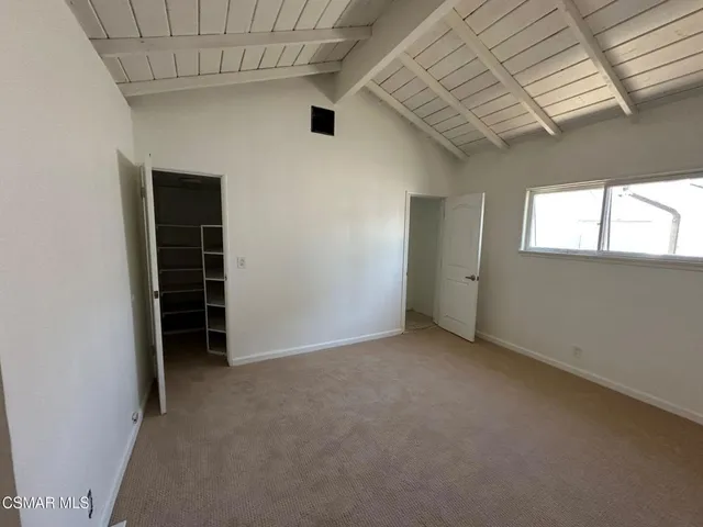 an empty room with a window and a ceiling fan
