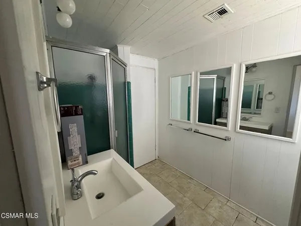 a bathroom with a sink and shower