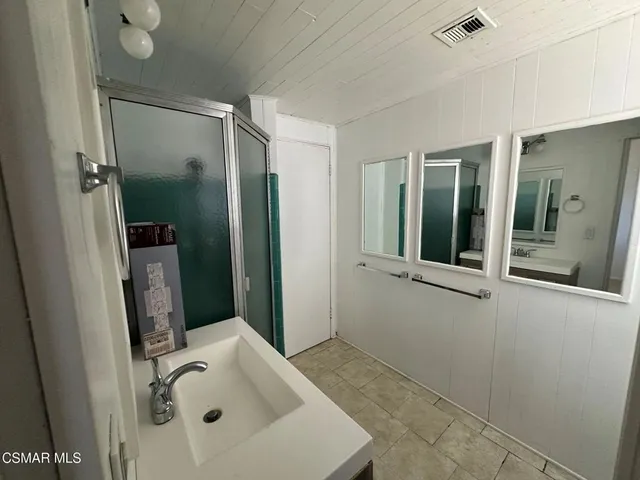 a bathroom with a sink and shower