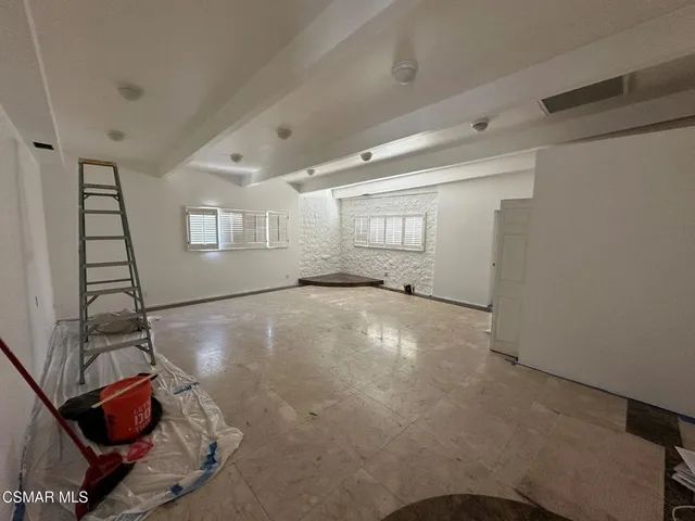 a view of a livingroom with wooden floor and white walls
