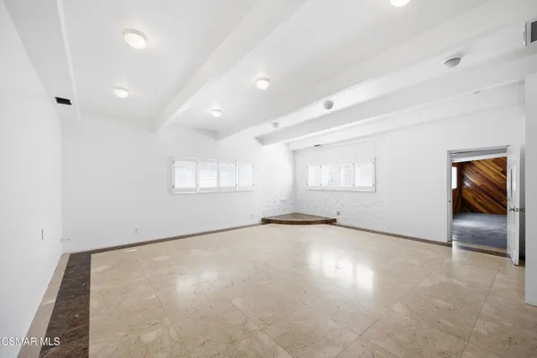 an empty room with windows and closet