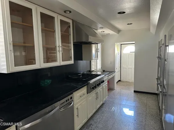 a kitchen with stainless steel appliances granite countertop a stove and a refrigerator