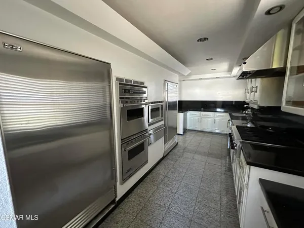 a kitchen with stainless steel appliances and view of counter top