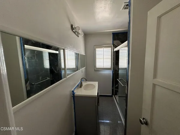 a hallway with windows and wooden floor