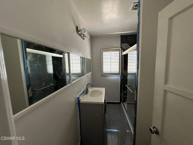 a hallway with windows and wooden floor