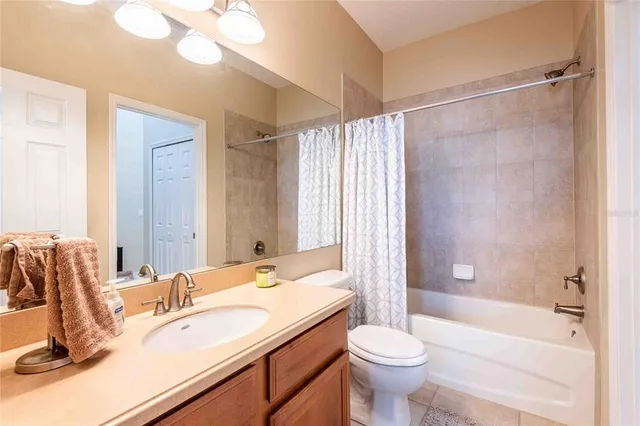 a bathroom with a double vanity sink toilet mirror and shower