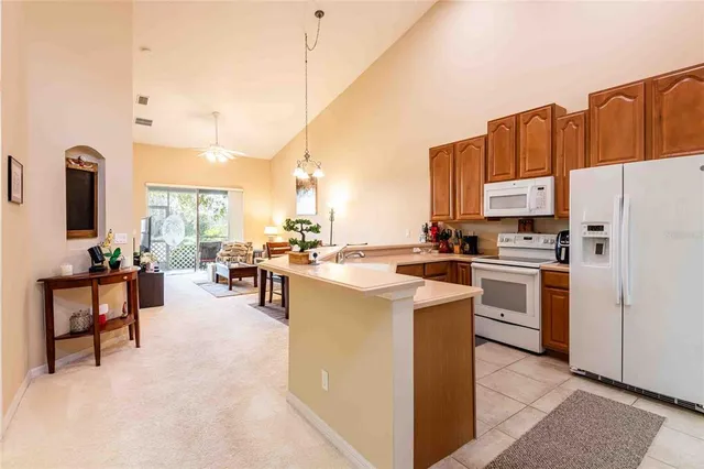 a kitchen with cabinets and chairs