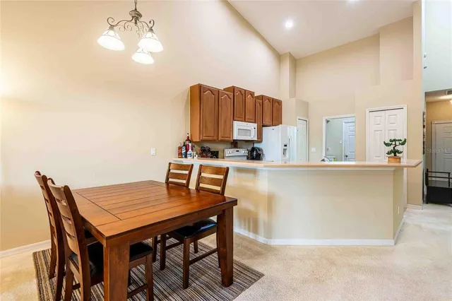 a kitchen with a kitchen island a stove a table and chairs