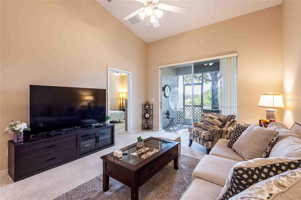 2735 Rutledge Court Winter Haven, FL 33884 - Photo 27 of 42 a living room with furniture and a flat screen tv
