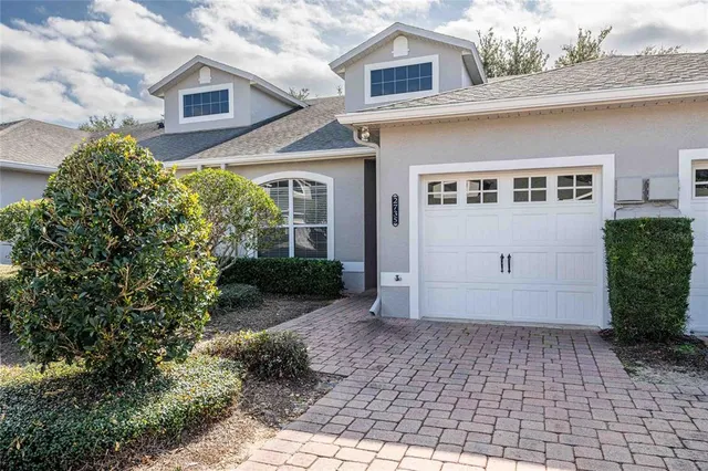 a view of a house with a yard and a garage