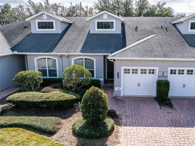 an aerial view of a house with outdoor space and lake view