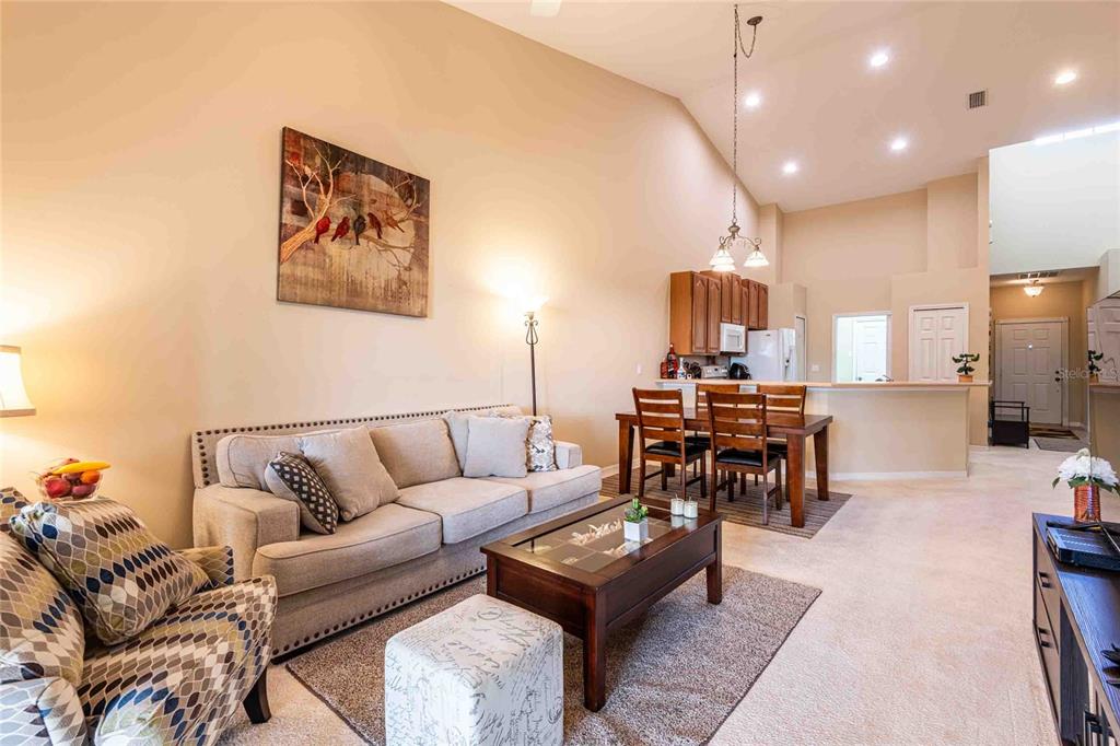 2735 Rutledge Court Winter Haven, FL 33884 - Photo 5 of 42 a living room with furniture and a dining table with rug